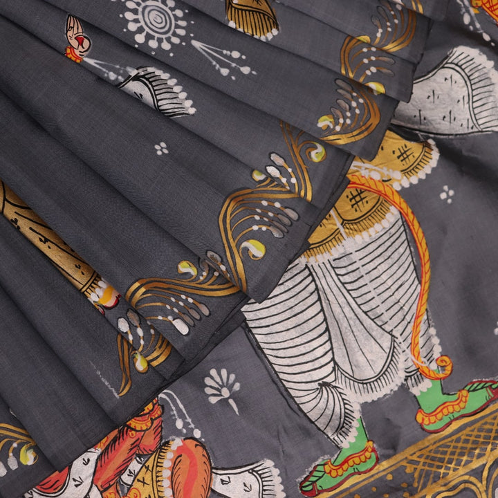 Close-up of handloom grey silk Patachitra saree fabric texture, revealing the intricate details of the hand-painted design.
