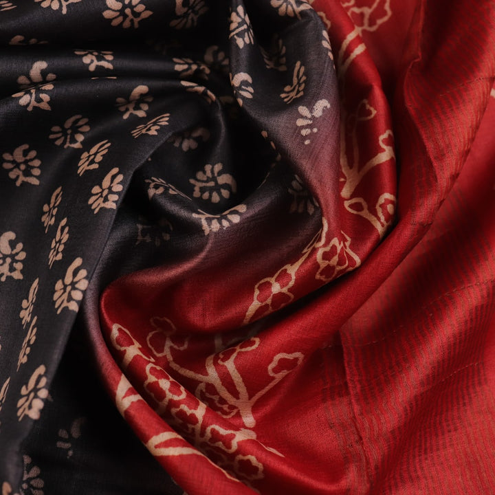 Close-up of the subtle slub and print on a handloom grey and rust Tussar silk saree fabric.