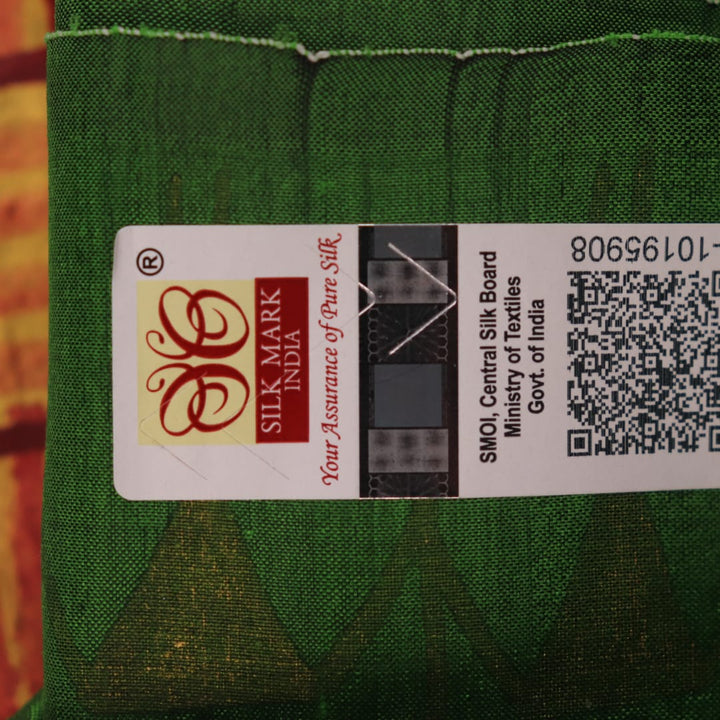 Close-up of green Patachitra silk saree, showcasing the handloom weave and fabric texture.