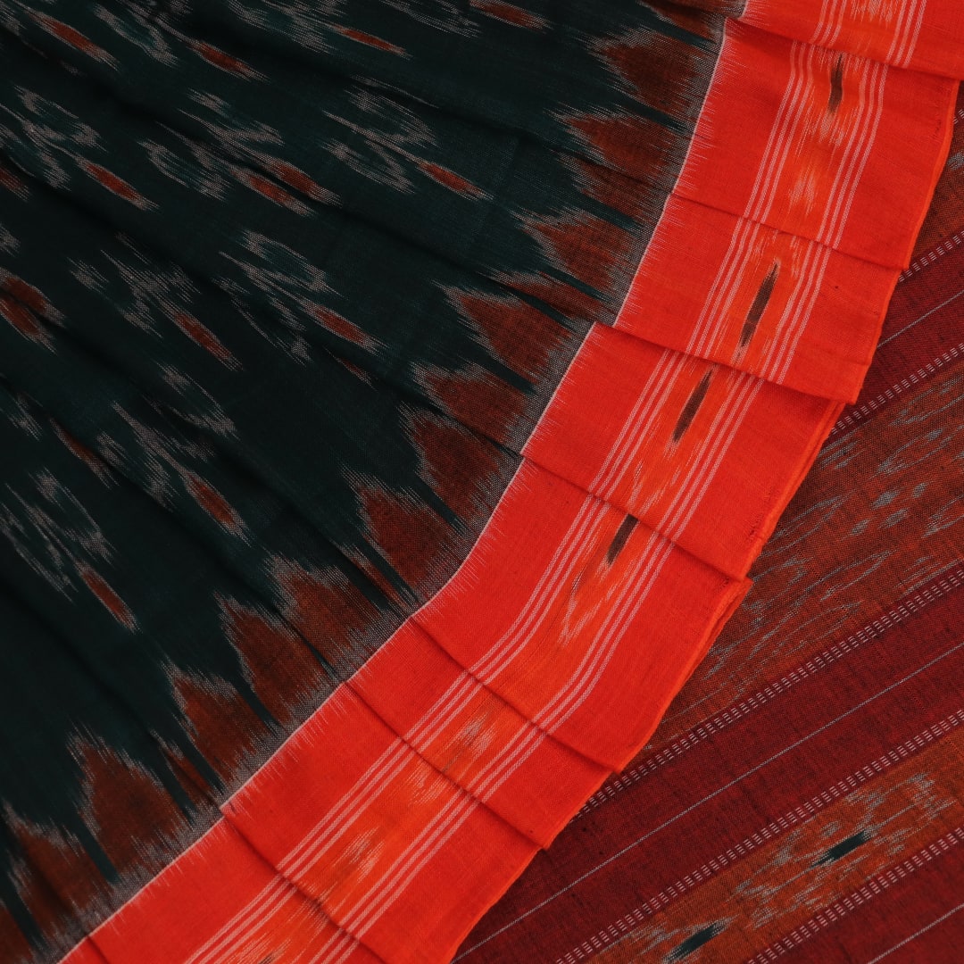 Green and orange Sambalpuri cotton saree draped, showcasing the motif pattern.