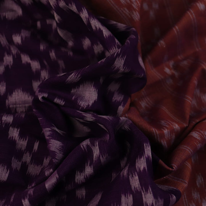 Violet & rust Sambalpuri cotton saree with motifs, elegantly draped.