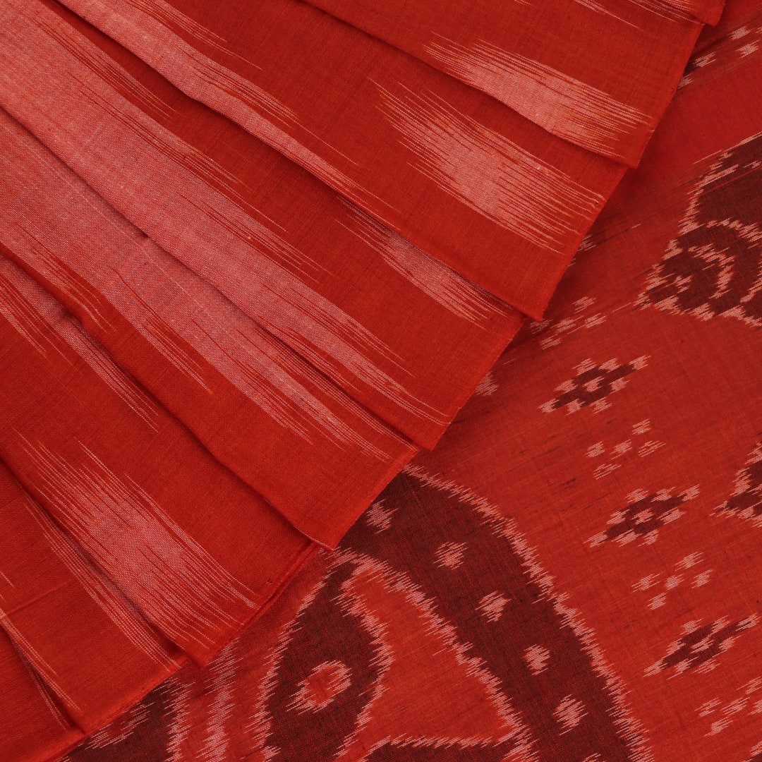 Styling view of a plain multi-color & rust Sambalpuri cotton saree.