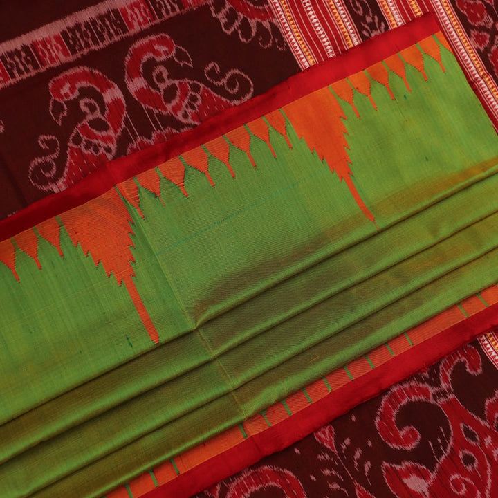 Close-up of plain green Sambalpuri silk saree fabric texture.