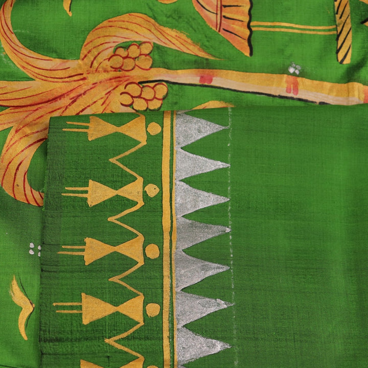 Close-up of green Patachitra silk saree, showcasing the handloom weave and fabric texture.