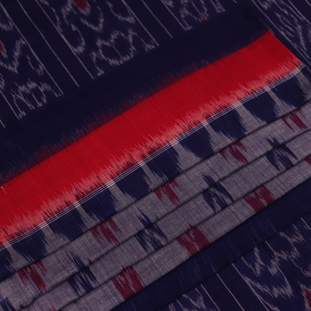 Blue Sambalpuri cotton saree with motifs, gracefully draped.