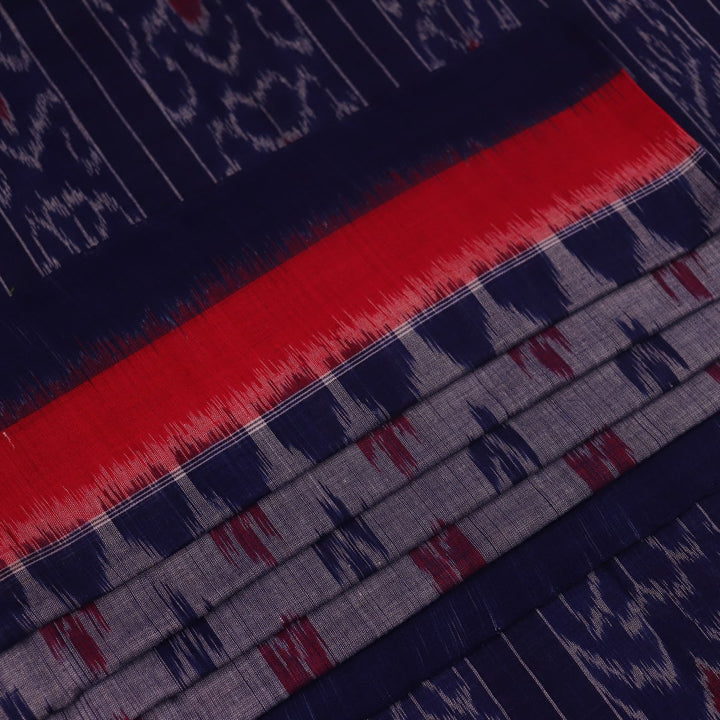 Blue Sambalpuri cotton saree with motifs, gracefully draped.
