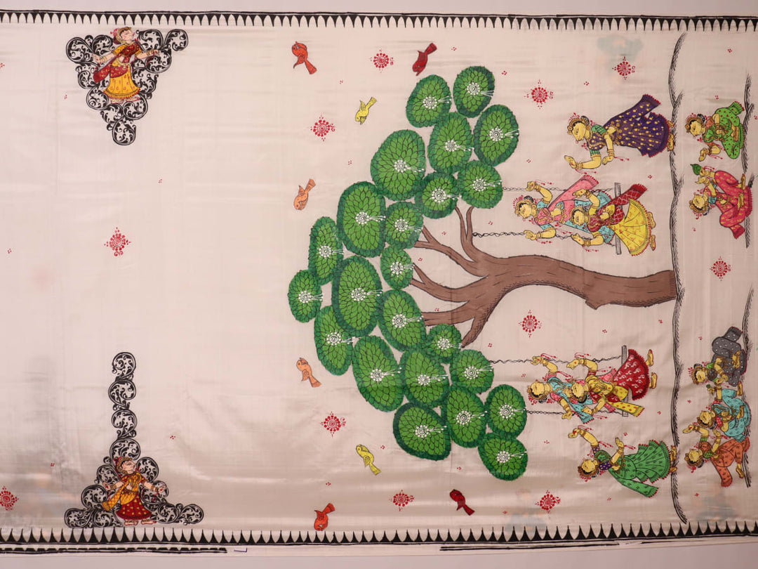 Close-up of white silk Patachitra saree fabric showing hand-painted texture and detail.