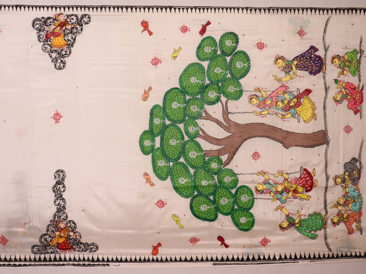 Close-up of white silk Patachitra saree fabric showing hand-painted texture and detail.