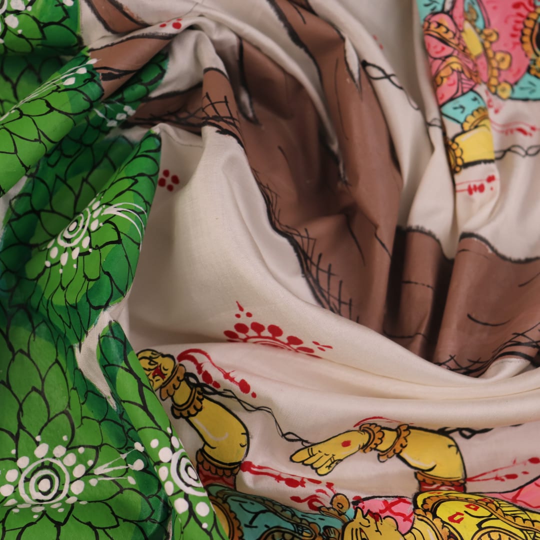 Close-up of white silk Patachitra saree fabric showing hand-painted texture and detail.