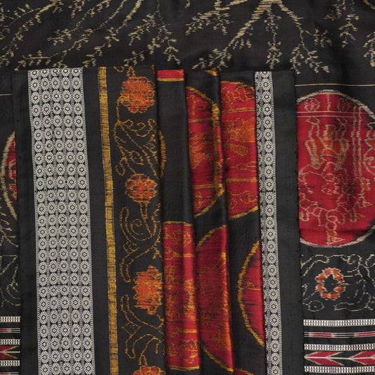 Close-up of the luxurious black Sambalpuri silk fabric, highlighting its rich texture and weave.