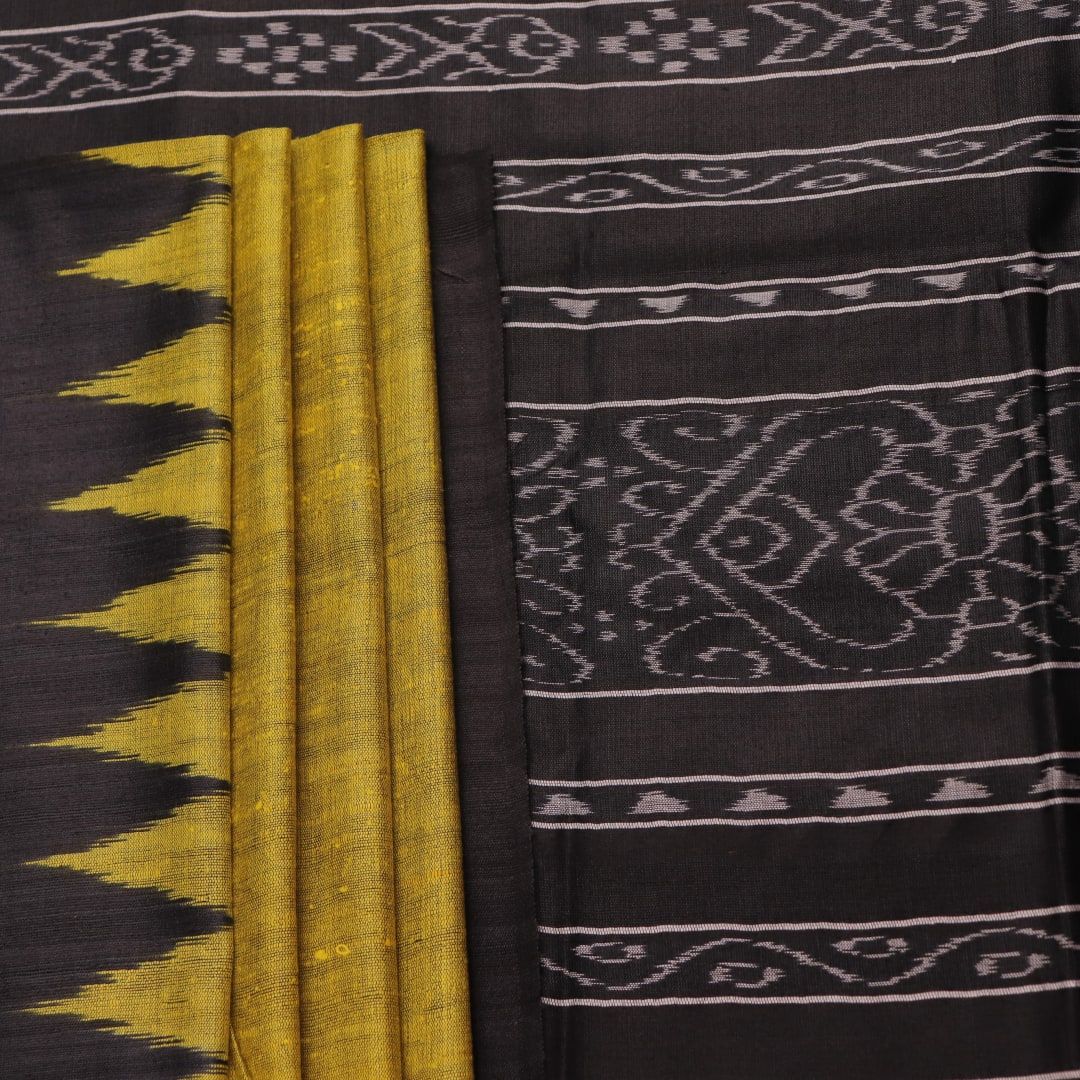 Close-up of the plain, slubby texture of a handwoven green and black Tussar silk saree.