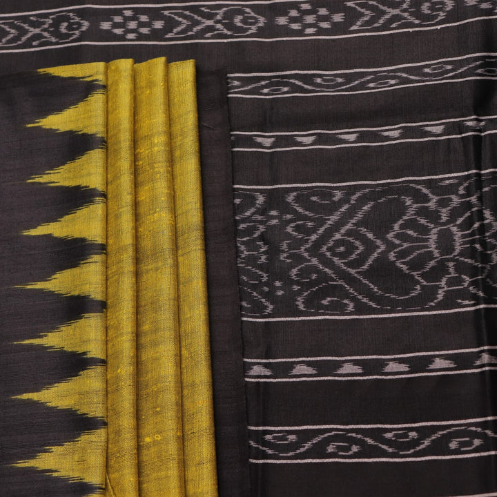 Close-up of the plain, slubby texture of a handwoven green and black Tussar silk saree.