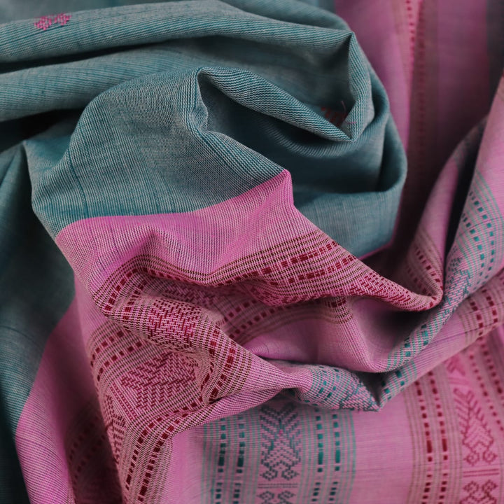 Full view of a plain handloom Sambalpuri cotton saree in green and peach.