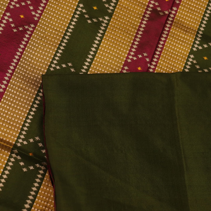 Close-up of the textured green Sambalpuri Silk Saree fabric, highlighting the woven butta pattern.