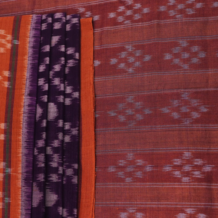Violet & rust Sambalpuri cotton saree with motifs, elegantly draped.