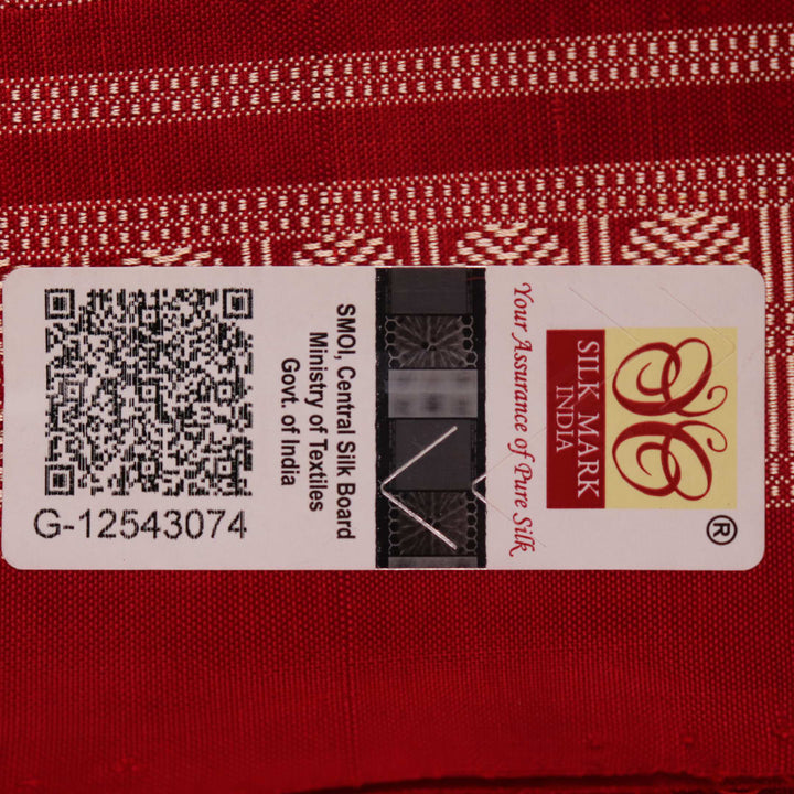 Close-up of multicolored silk Sambalpuri saree fabric showing intricate handloom weave texture.