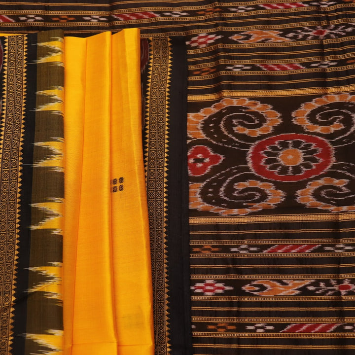 Model showcasing yellow Khandua silk saree with black butta pattern.