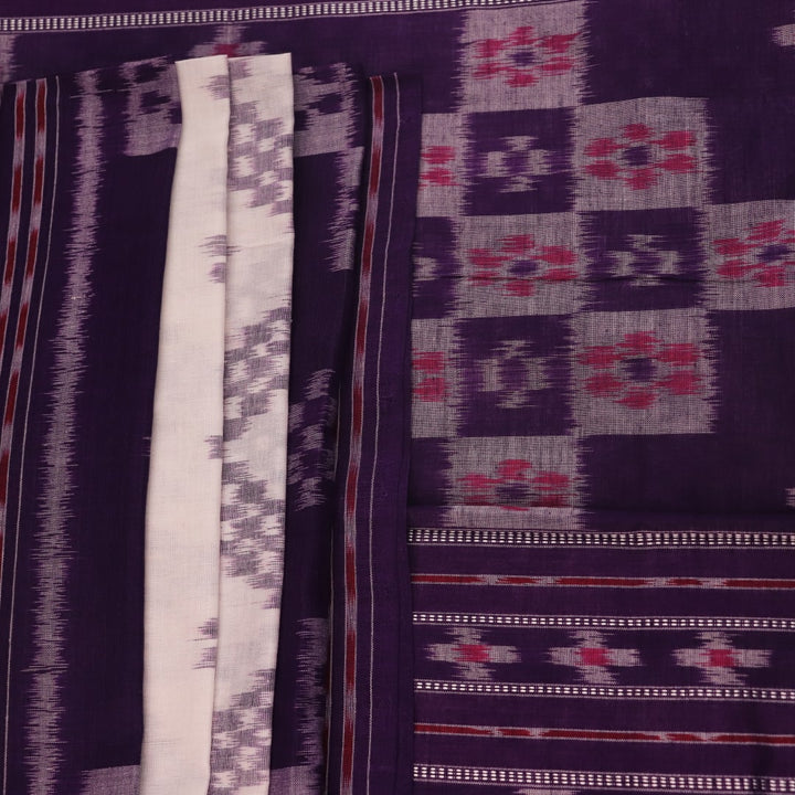 Elegantly draped red and violet Sambalpuri cotton saree with traditional motifs.