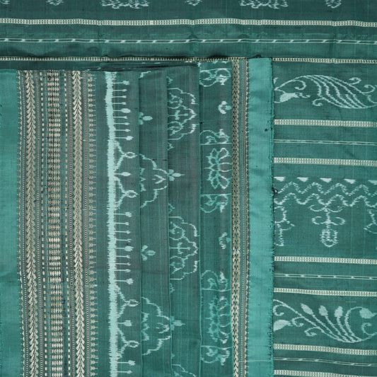 Close-up of green Sambalpuri silk fabric, showing its luxurious texture and fine handloom weave.