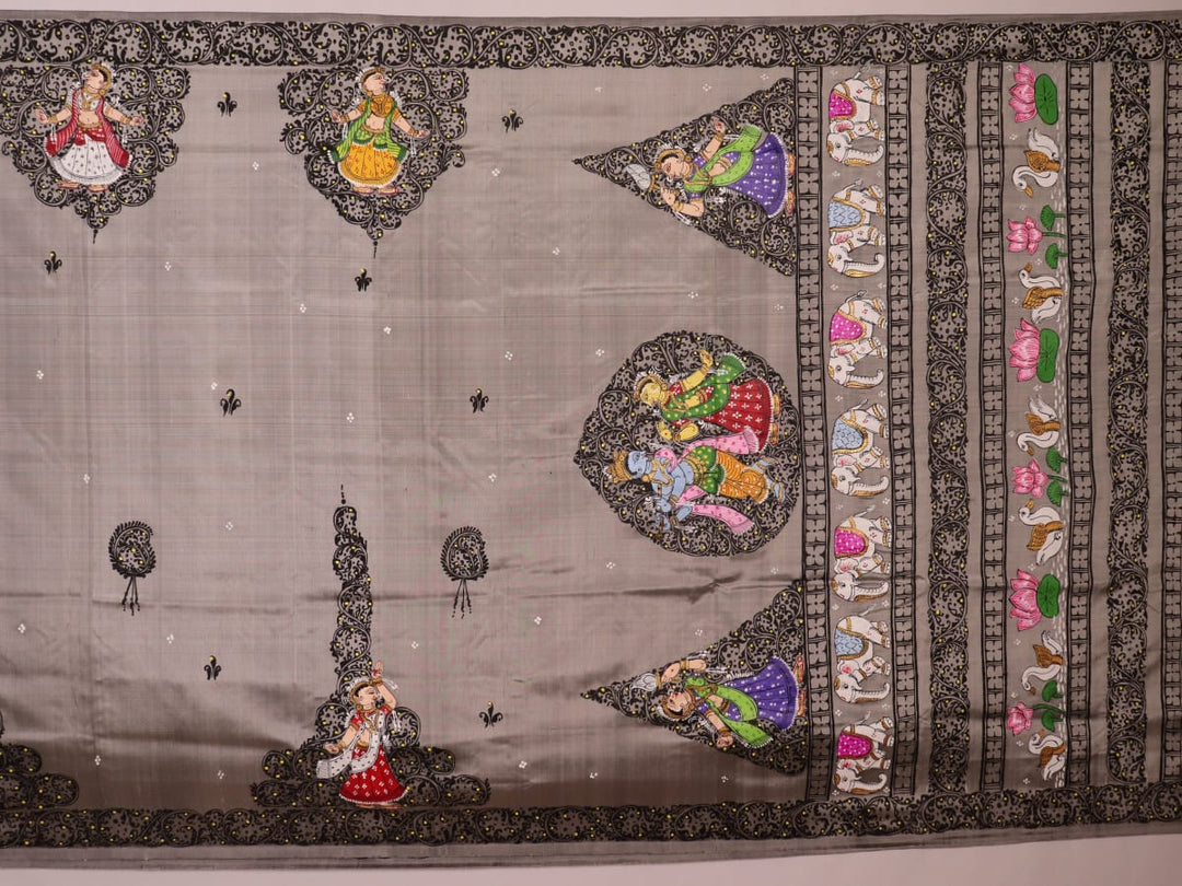 Close-up of grey silk Patachitra saree fabric showing hand-painted texture and intricate weave detail.