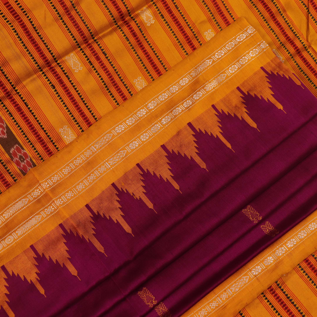 Close-up fabric texture of a magenta Sambalpuri Silk Saree with yellow butta pattern.