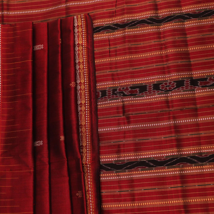 Close-up of maroon Sambalpuri Silk Saree fabric, showing intricate butta weave texture.