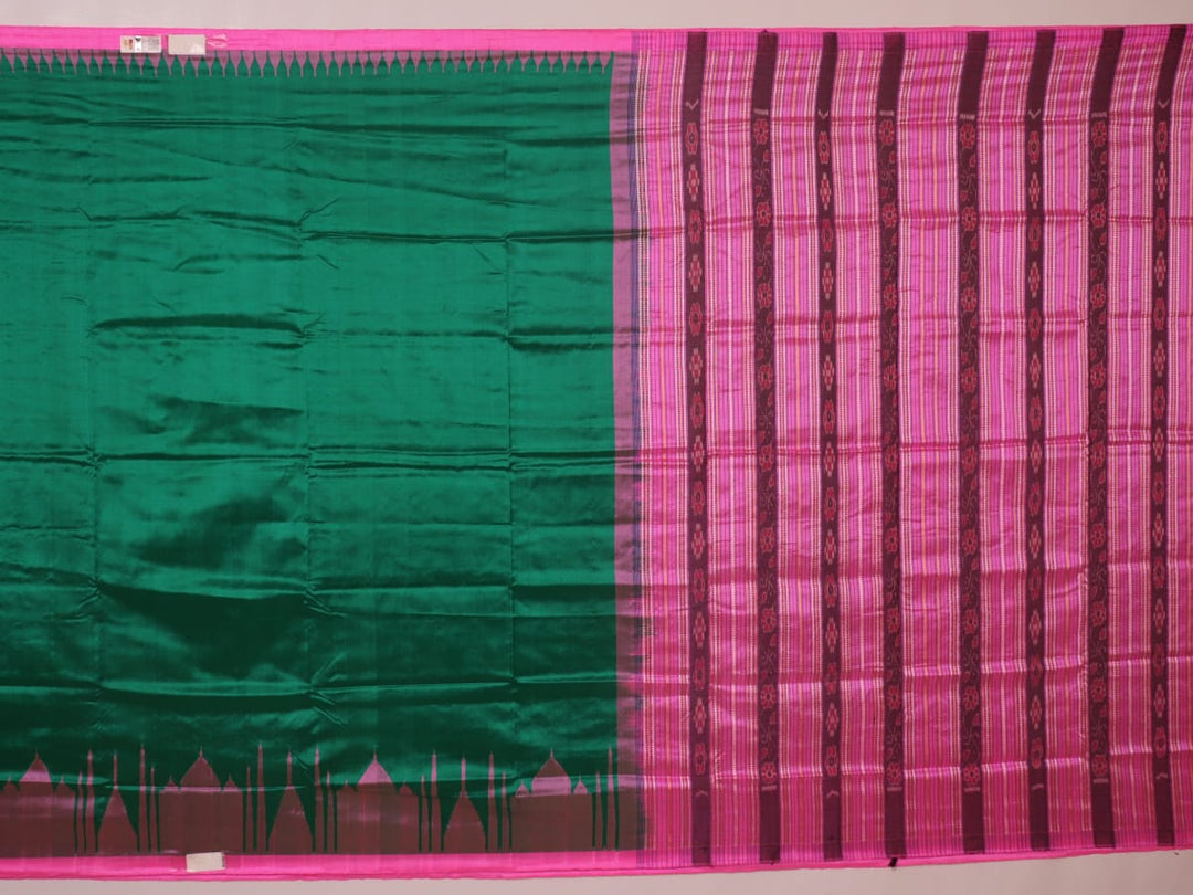 Close-up of plain green and pink Sambalpuri silk saree fabric texture.