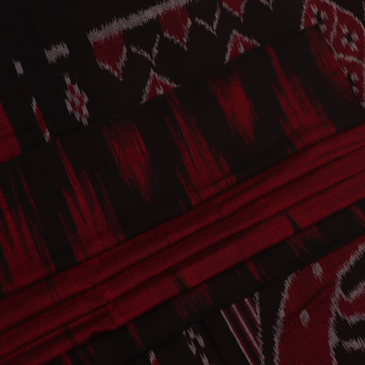 Gracefully draped maroon and black plain Sambalpuri cotton saree.