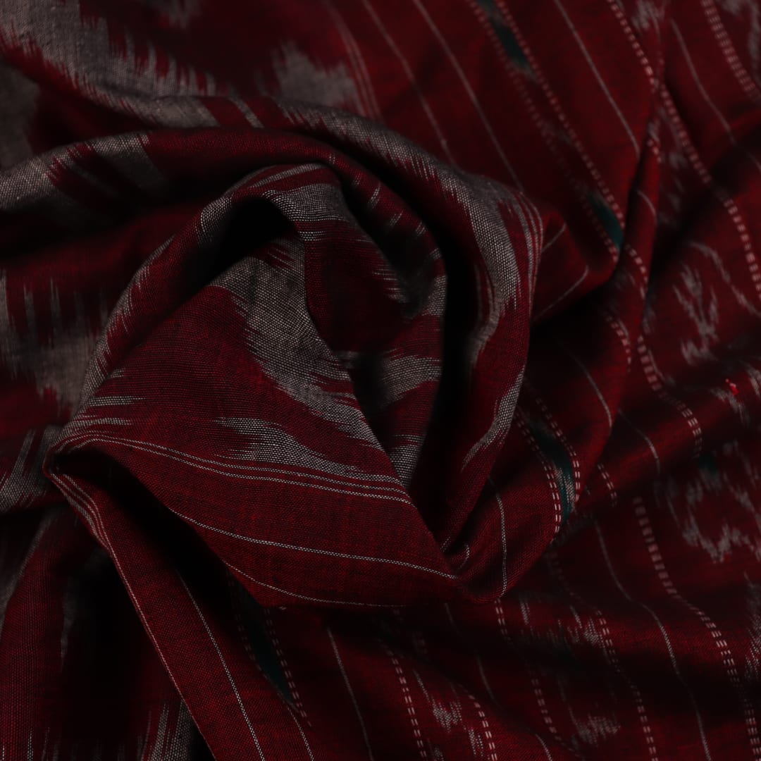 Grey and red Sambalpuri cotton saree draped to show its fall, style, and motif pattern.