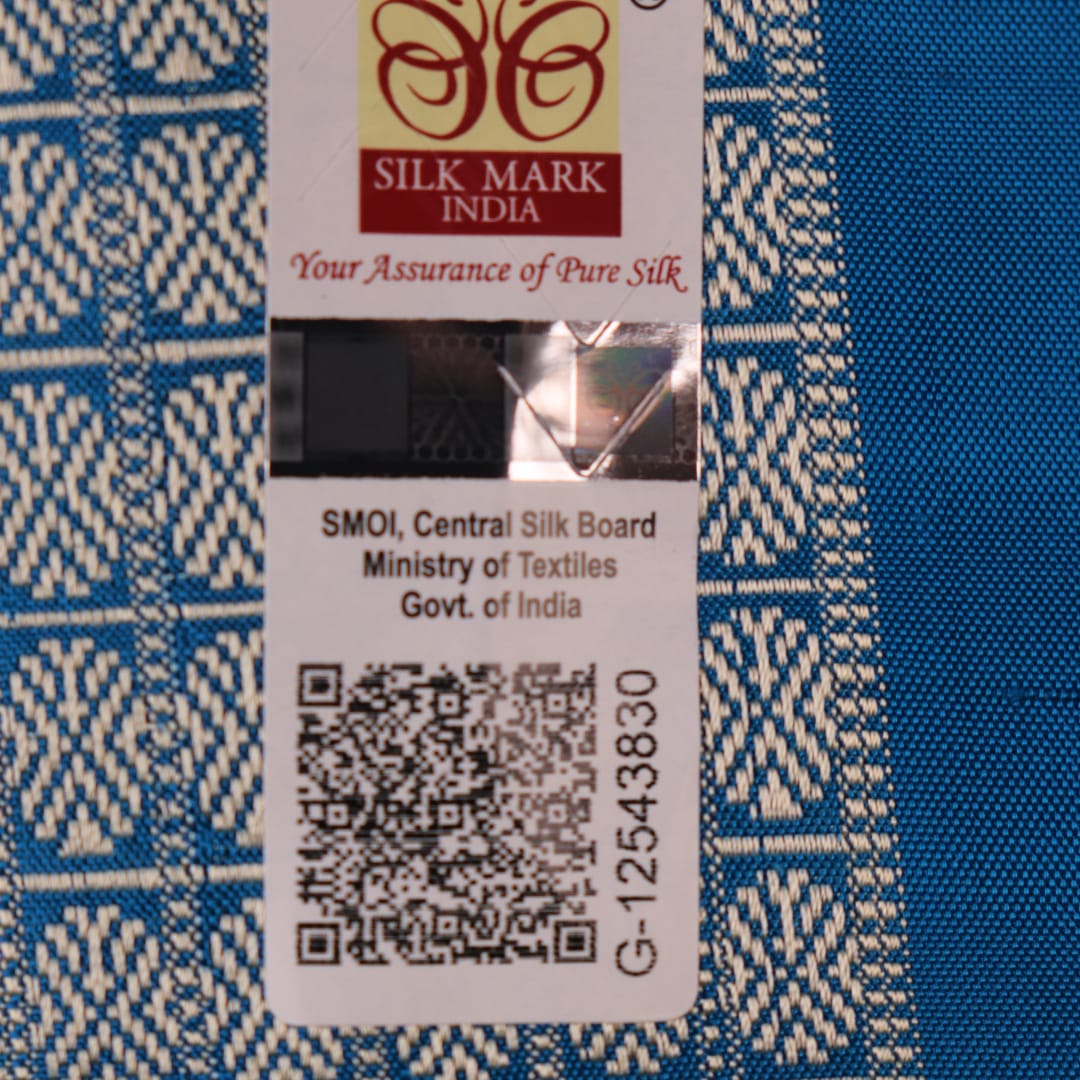 Close-up of black Sambalpuri silk saree fabric texture, showcasing the weave and subtle motif details.