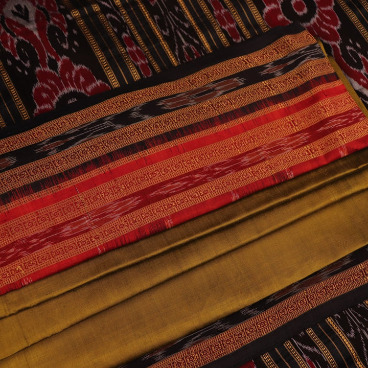Green and black Khandua silk saree draped; showcasing its butta pattern and elegant fall.
