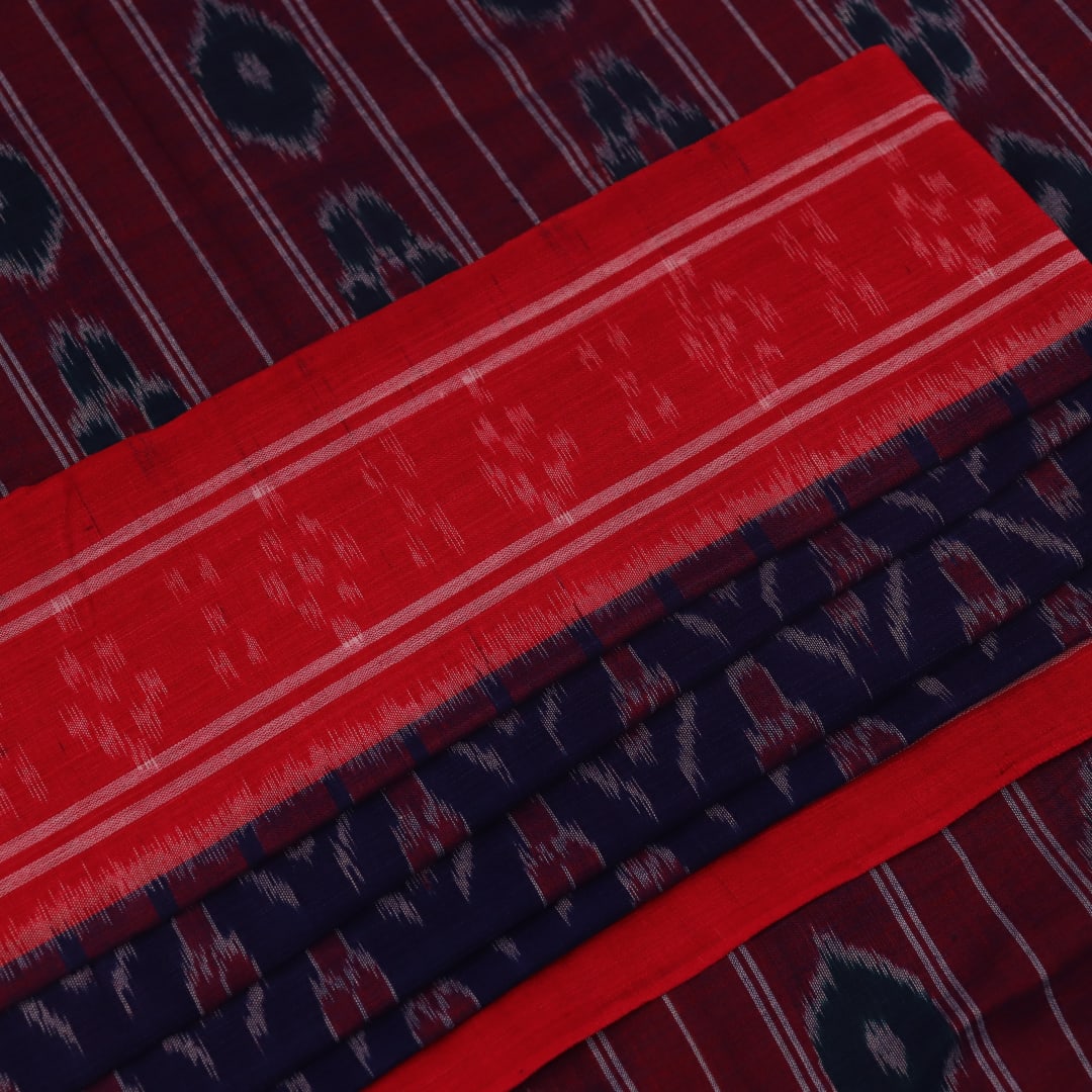 Gracefully draped blue Sambalpuri cotton saree with red motifs, highlighting its design and flow.