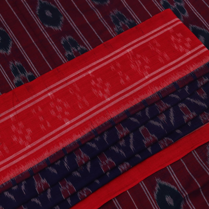Gracefully draped blue Sambalpuri cotton saree with red motifs, highlighting its design and flow.