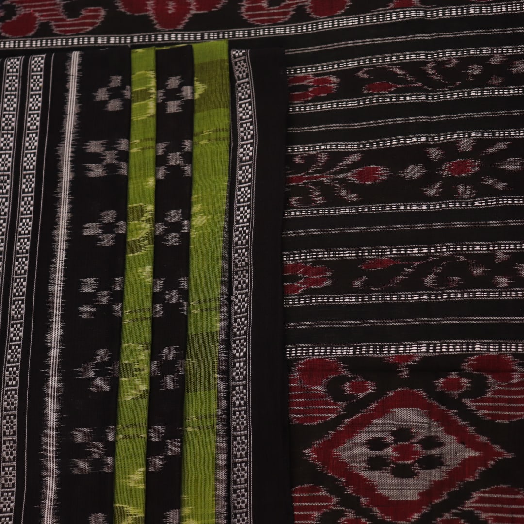 Styled green and black cotton Sambalpuri handloom saree with motifs, showcasing its elegant drape.