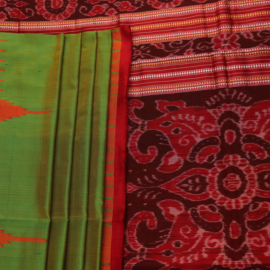 Close-up of plain green Sambalpuri silk saree fabric texture.
