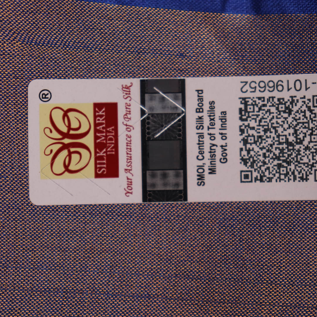 Close-up of blue printed Tussar silk handloom saree fabric texture.