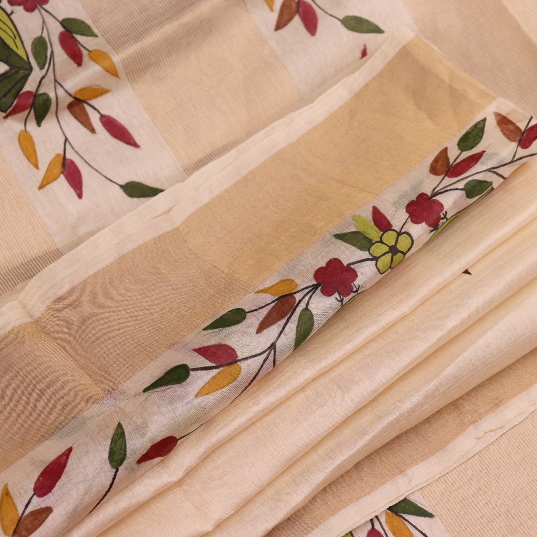 Close-up of off-white printed Tussar Silk saree fabric texture.