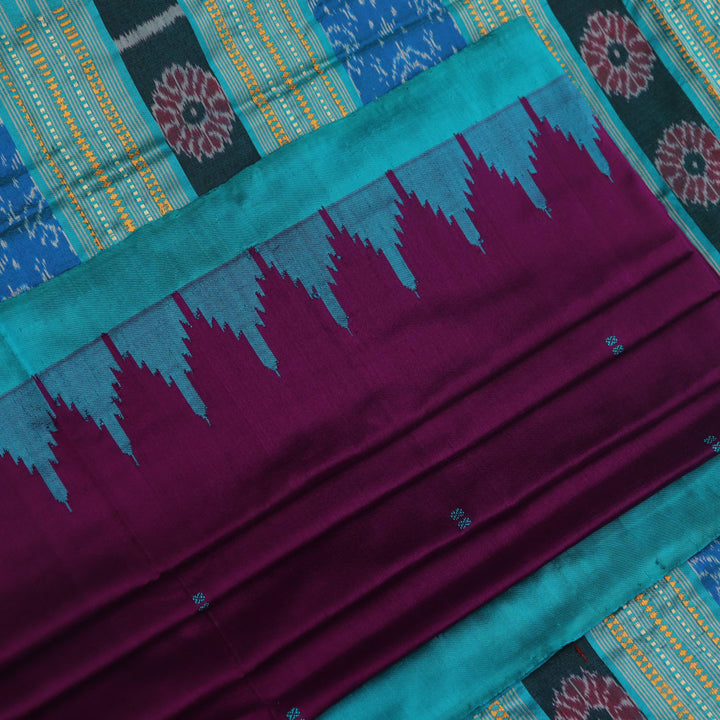 Close-up of the textured weave of a purple Sambalpuri silk saree with green accents and butta pattern.