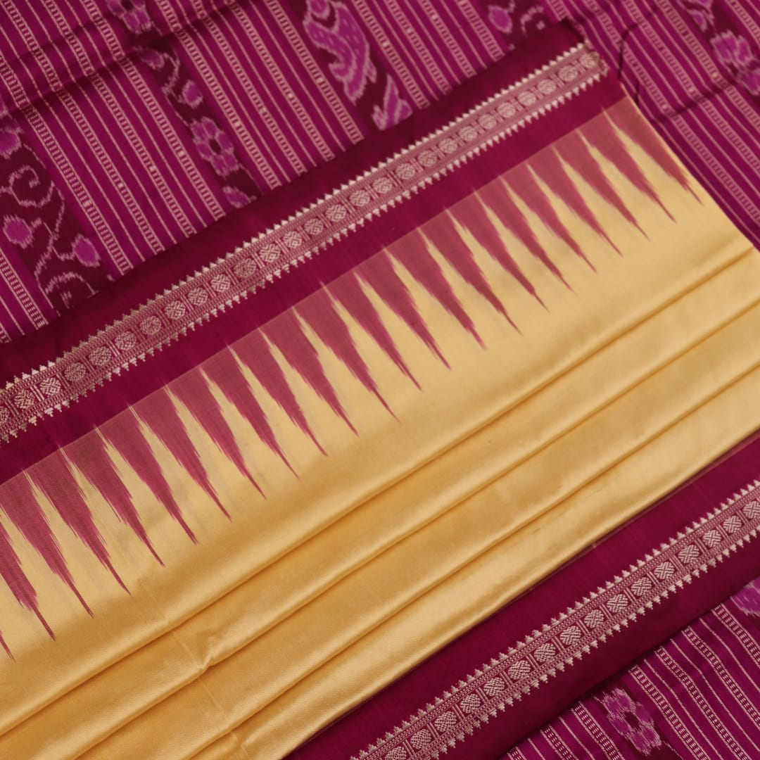 Close-up of plain cream and magenta Sambalpuri Silk Saree fabric texture.