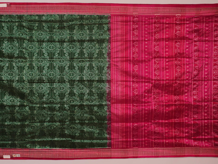 Close-up of textured green Sambalpuri silk saree fabric with magenta motifs.