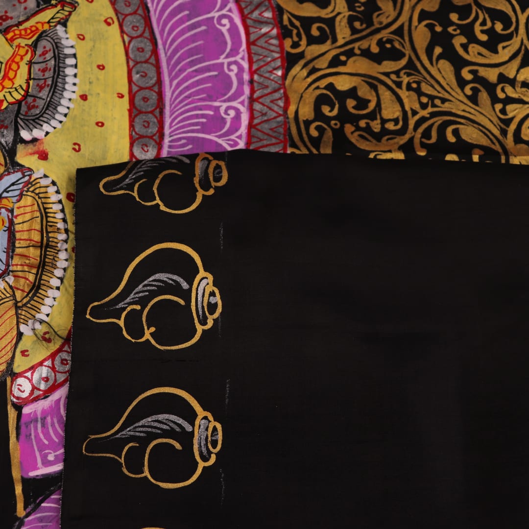 Close-up of black silk Patachitra saree fabric, showcasing hand-painted texture and detail.
