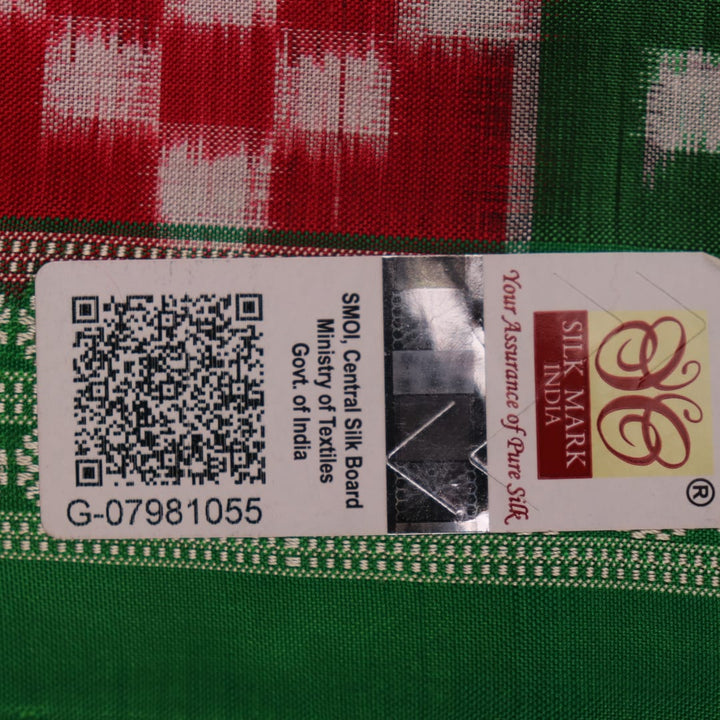 Close-up of magenta Sambalpuri silk saree fabric texture, showcasing intricate handloom weave and subtle motifs.