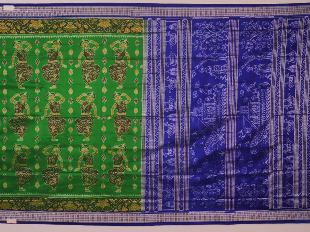 Close-up of green and blue Sambalpuri silk saree fabric showing intricate handloom weave and motif details.