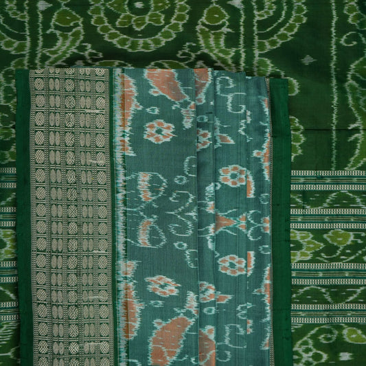 Ultra close-up of green Sambalpuri silk saree fabric, highlighting its luxurious texture and weave.