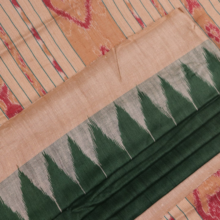 Close-up of the green and off-white plain Tussar silk saree, highlighting its natural slub texture.