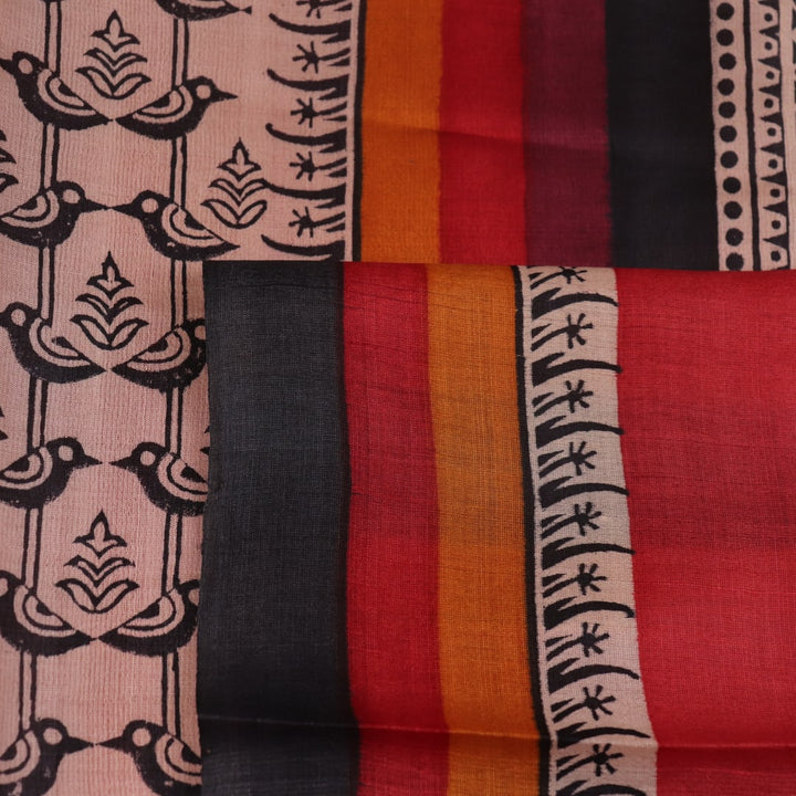 Close-up of off-white Tussar silk fabric, highlighting natural slubs and printed black pattern.
