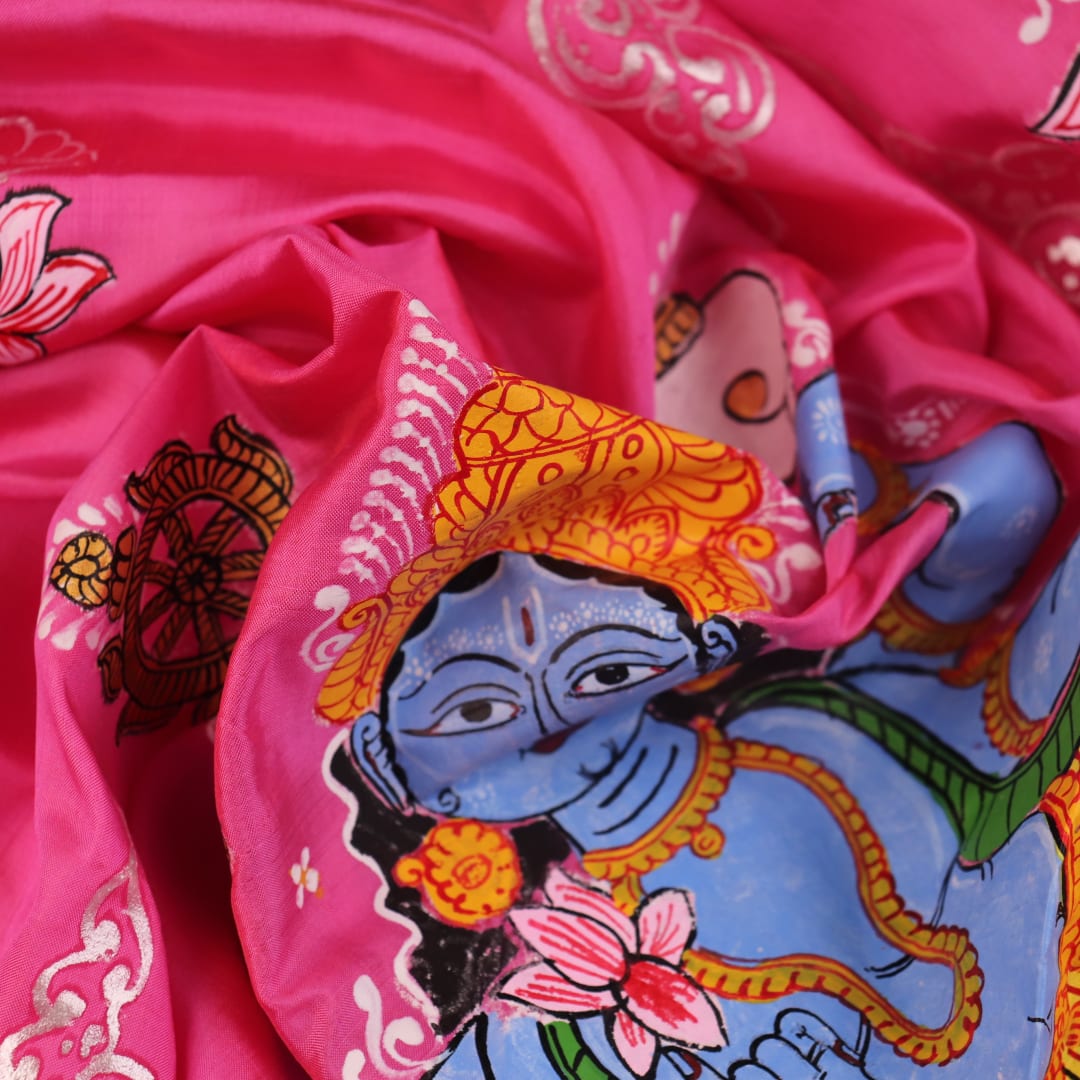 Close-up of pink silk Patachitra saree fabric, showcasing hand-painted texture and fine details.