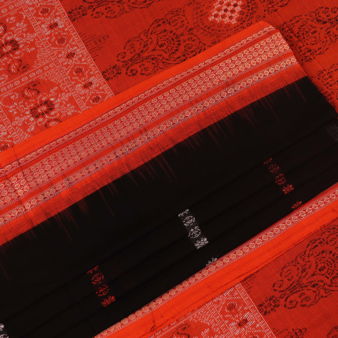 Full view of a black and orange Bomkai cotton handloom saree with butta pattern.