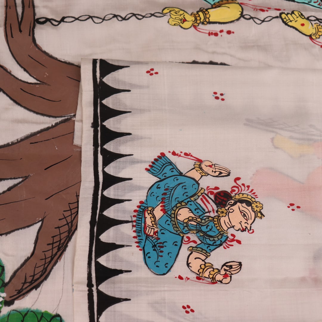 Close-up of white silk Patachitra saree fabric showing hand-painted texture and detail.