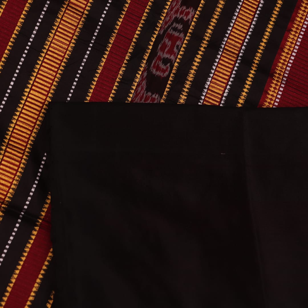 Textured close-up of red and black Sambalpuri Silk Saree fabric, highlighting the woven butta pattern.